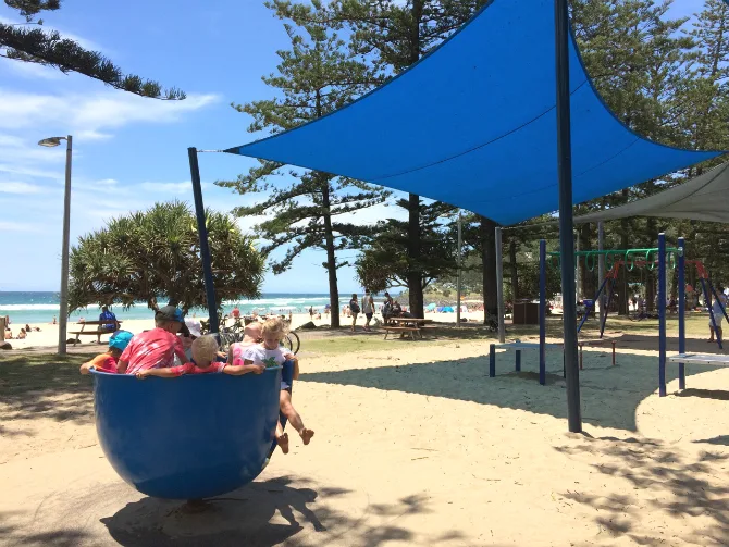 kids on blue spinner at justins park the esplanade gold coast