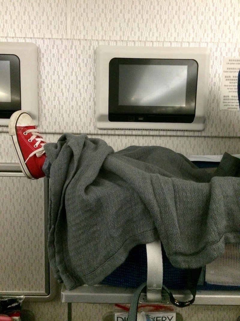 plane trips with baby basinette in the bulkhead pic