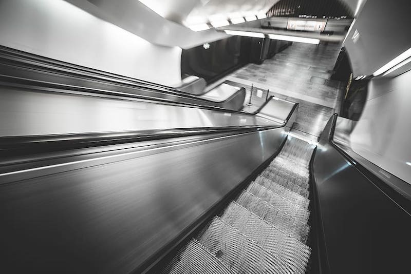 riding the paris metro with stroller on the escalator pic