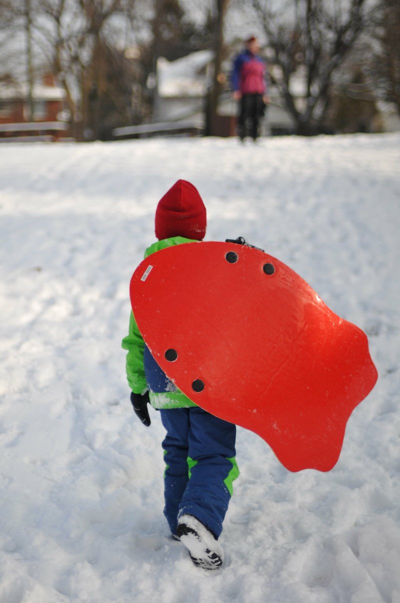 child on sled by quio media group