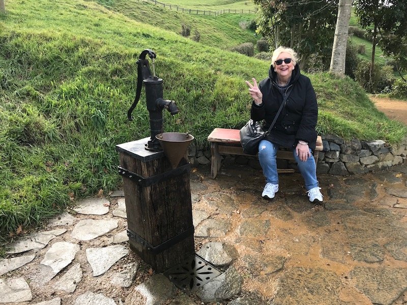 hobbiton movie set tours in new zealand - mum sitting at rest area pic