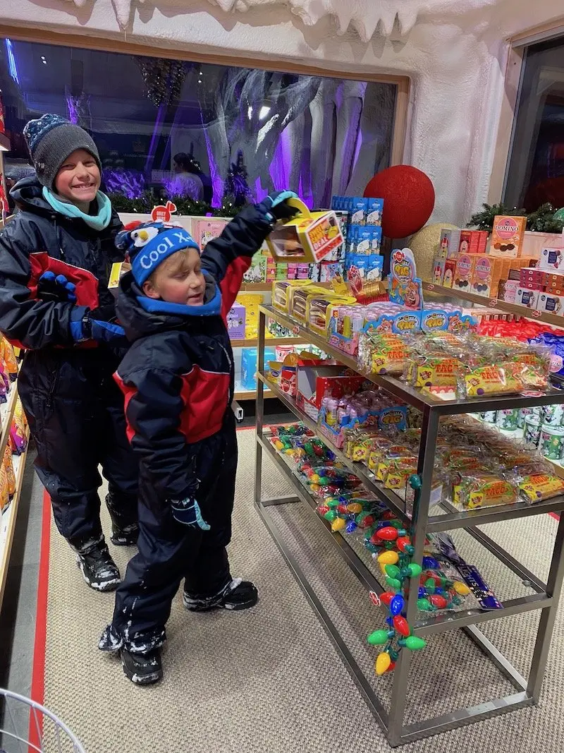 Image - kids at the lolly section inside Karl fazer shop santa village