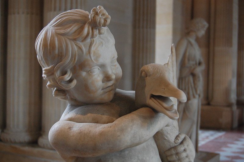 louvre museum with kids sculpture of child and duck pic