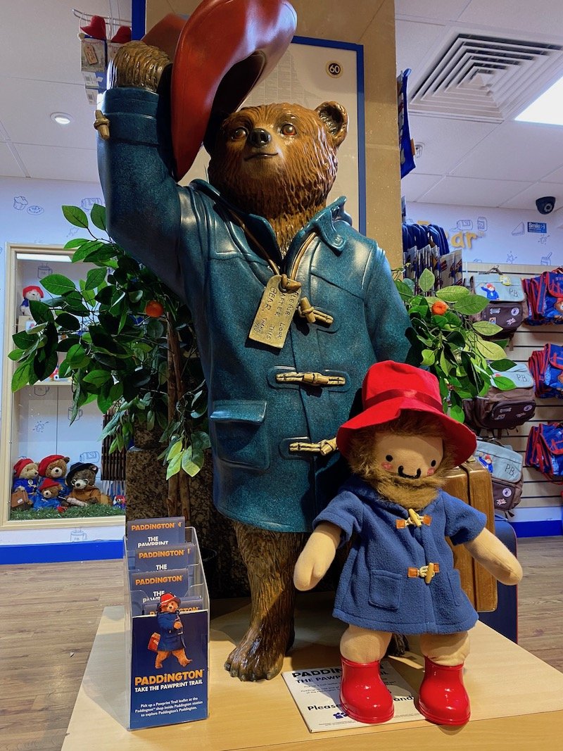 paddington bear shop in london statue in shop with roam the gnome pic