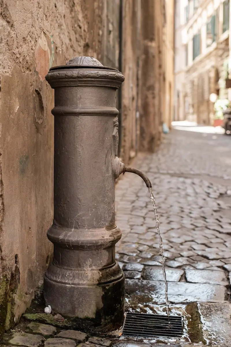 street-drinking-fountain-on-paved-narrow-sidewalk