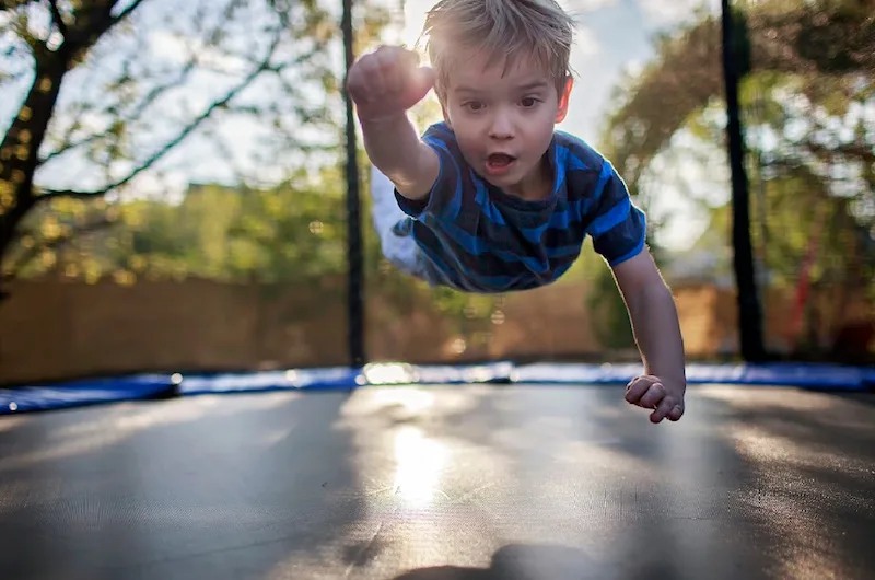 image - superman kid on trampoline
