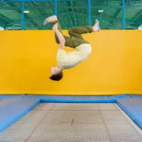 image - trampoline tricks with yellow wall